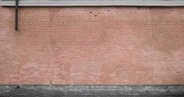The texture of the brick wall of many rows of bricks painted in brown color photo