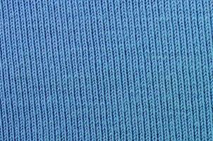 The texture of the fabric in blue color. Material for making shirts and blouses photo