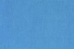 The texture of the fabric in blue color. Material for making shirts and blouses photo