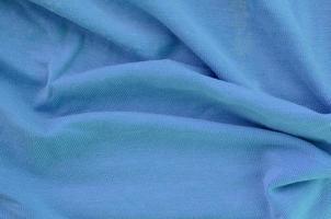 The texture of the fabric in blue color. Material for making shirts and blouses photo