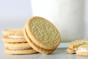 TERNOPIL, UKRAINE - MAY 28, 2022 Oreo golden crispy cookies with glass of milk on white background. The brand Oreo is owned by company Mondelez international photo