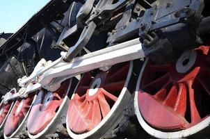 Red wheels of steam train photo