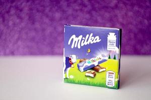 TERNOPIL, UKRAINE - JUNE 3, 2022 Milka milkinis small pack with chocolate finger bars. Milka is a Swiss brand of chocolate confection manufactured by company Mondelez International photo