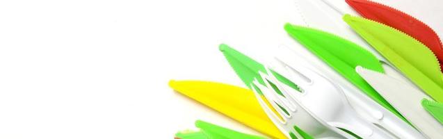 Pile of bright yellow, green and white plastic kitchenware single use appliances photo
