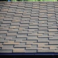 Modern roofing and decoration of chimneys. Flexible bitumen or slate shingles photo