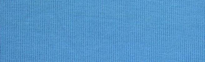 The texture of the fabric in blue color. Material for making shirts and blouses photo