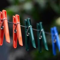 Clothespins on a rope hanging outside house and apple tree photo