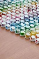 A pattern from a many nozzles from a paint sprayer for drawing graffiti, smeared into different colors. The plastic caps are arranged in many rows forming the color of the rainbow photo