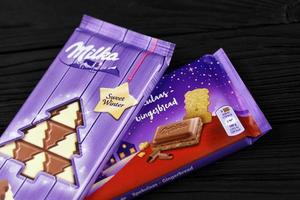 KHARKIV, UKRAINE - JANUARY 27, 2022 Milka sweet winter and spekulaas gingerbread chocolate bar. Milka is Swiss brand of chocolate confection manufactured by company Mondelez International photo