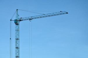 Tower crane against a blue sky photo