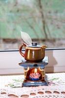 ceramic aroma lamp in the form of a teapot with a candle