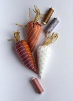 Easter needlework, sewing tools, thread,  fabric carrots, decor for decorating the house for Easter. Space for text. photo