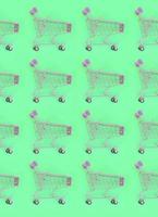 Shopping addiction, shopping lover or shopaholic concept. Many small empty shopping carts perform a pattern on a pastel colored paper background. Flat lay composition, top view photo