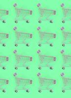 Shopping addiction, shopping lover or shopaholic concept. Many small empty shopping carts perform a pattern on a pastel colored paper background. Flat lay composition, top view photo