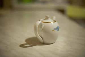 Kettle for tea on table. Item in kitchen. Glass kettle. photo