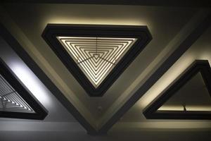 Triangular light source. Lamp in interior. Designer light. Architecture details. photo