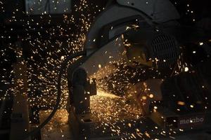 Sparks in dark. Cutting steel. Industrial equipment. photo