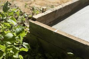 Construction work. Formwork with cement. Pouring foundation. photo