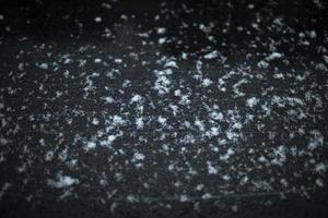 Snow on glass. Snow on car window. After snowstorm. Precipitation on surface. photo