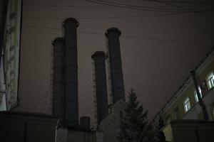 Factory at night. Pipes in dark. Industrial zone in city. photo