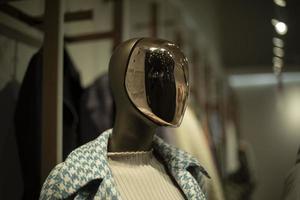 Golden mask on face. Mannequin in clothing store. Figure of person without face. photo