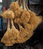 Set of yellow straw broom in bazaar