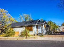 Small Abandoned House With Boarded Up Windows photo