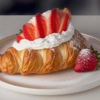 Croissant on the white plate, with fresh strawberry and whipped cream. photo