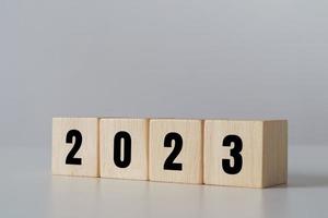 start to year 2022. wooden cube block with 2023 year text. happy new years concept. photo