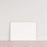 Empty picture frame on wooden floor leaning against wall. Blank poster frame standing on wooden floor. Blank poster frame mockup. Empty picture frame mockup. 3d rendering. photo