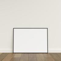 Empty picture frame on wooden floor leaning against wall. Blank poster frame standing on wooden floor. Blank poster frame mockup. Empty picture frame mockup. 3d rendering. photo