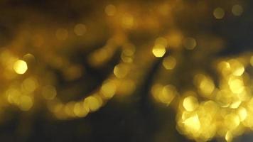 Abstract golden texture in blurry light for background animation. Glitter pattern for video effect, transition and overlay