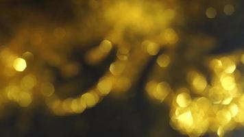 Abstract golden texture in blurry light for background animation. Glitter pattern for video effect, transition and overlay