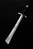 Falchion on a dark background. photo