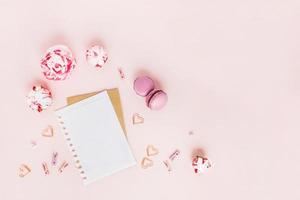 Card with peonies and macaroons with hearts. photo