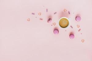 Card with peonies and macaroons and coffee with hearts. photo