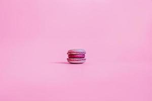 One macaroon on a purple background. photo