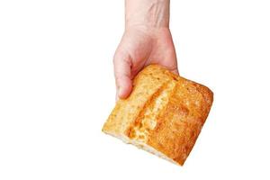 Bread in the hand of a middle-aged woman. The concept of the world food crisis associated with the war in Ukraine. Isolated on white background photo