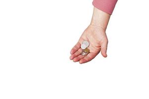 Last money for groceries. Coins in the hand of a middle-aged woman. The concept of the world food crisis associated with the war in Ukraine. Isolated on white background photo