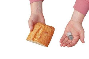 Last money for bread. Bread in the hand of a middle-aged woman. The concept of the world food crisis associated with the war in Ukraine. Isolated on white background photo