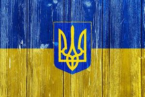 Flag and coat of arms of Ukraine on a textured background. conceptual collage. photo