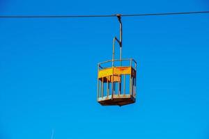 Old cable car in Dnepropetrovsk. Cable car cabins against the background of the blue sky and the urban landscape. photo