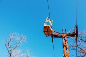 Old cable car in Dnepropetrovsk. Cable car cabins against the background of the blue sky and the urban landscape. photo