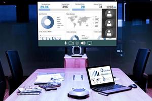 Mock up chart slide show presentation on display television and laptop in meeting room photo