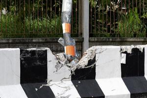 Electric poles and barrier broken by car crash. photo