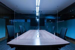 Television blank display in video conference meeting room with clear acrylic sheet separates the center on the conference table to prevent Covid-19 photo