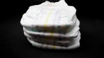 Baby diapers stacked each other on isolated background. photo