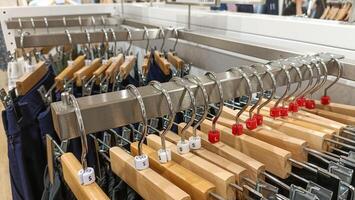 top view of hanging clothes arranged on a display rack. photo