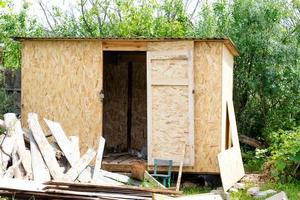 Construction of a wooden shed in a garden outside the city photo