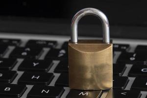 internet and computer security represented by a closed padlock over a black keyboard photo